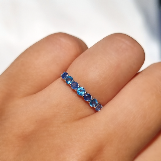 Blue sapphire and blue topaz half eternity band in sterling silver by Vianne Jewellery